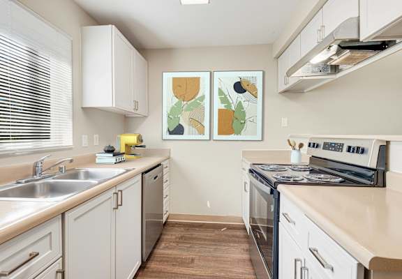 a modern kitchen with white cabinets and stainless steel appliances