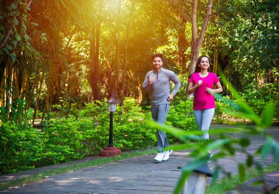 a couple jogging in a park