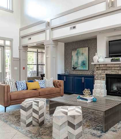A living room with a fireplace and a television on the wall.