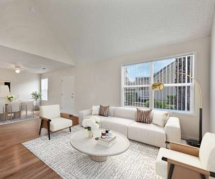 a living room with a white couch and a table