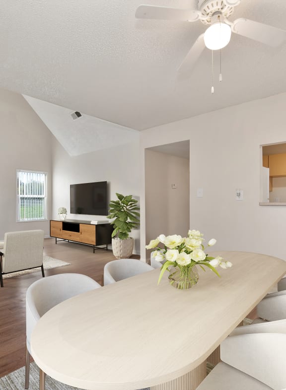 a living room with a table and chairs and a kitchen at Vineyard Terrace Apartments, Napa, CA