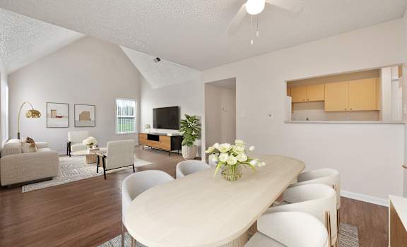 a living room with a dining room table and chairs