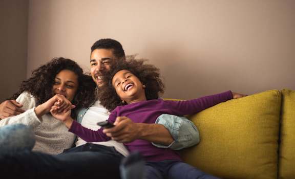 a group of people sitting on a couch watching tv  at Linden Ridge, Stone Mountain, 30083