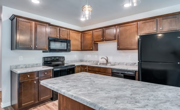 a kitchen with an island and a breakfast bar