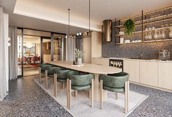 A modern dining area with a long table and green chairs.