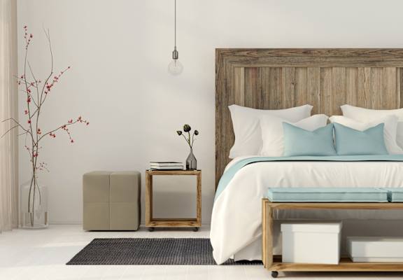 a bedroom with a bed and a wooden headboard