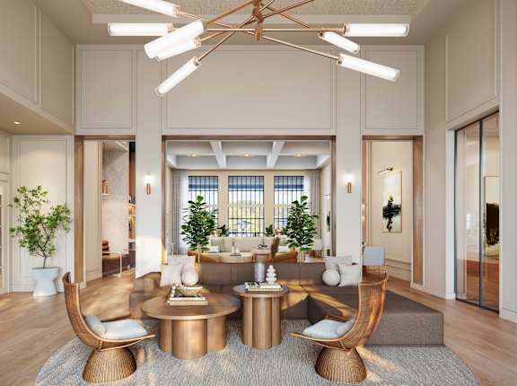 A modern living room with a large window and a copper-colored coffee table.