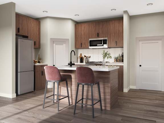 A kitchen with a bar stool and a refrigerator.