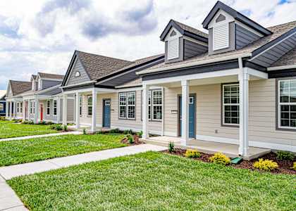 A row of houses with blue doors and windows at French District Villas Apartments, St. Charles, 63301