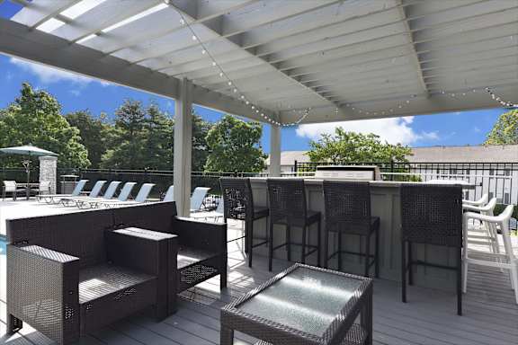 A patio with a table and chairs under a white canopy.