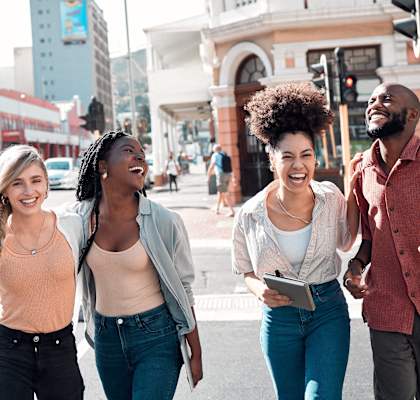 a group of people walking down a city street