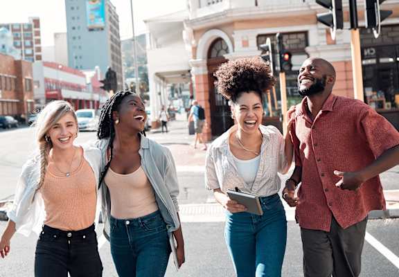a group of people walking down a city street