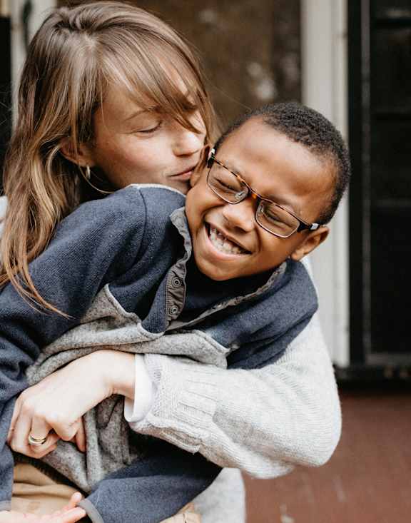 a young girl kissing a young boy on the cheek