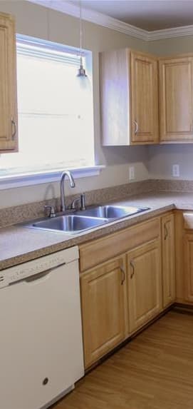 a kitchen with white cabinets and a black stove and refrigerator