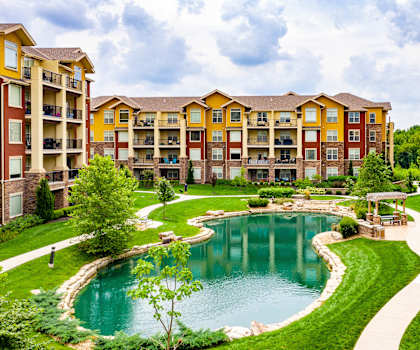 A large building with a pool in front of it.