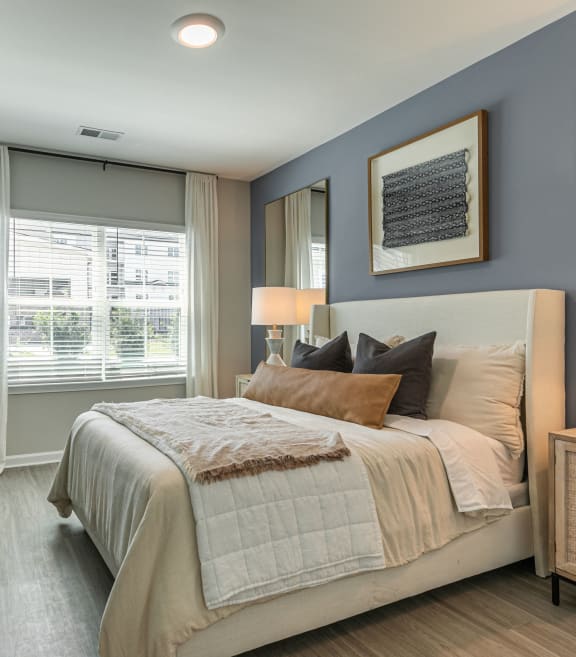 a bedroom with a large bed and a window