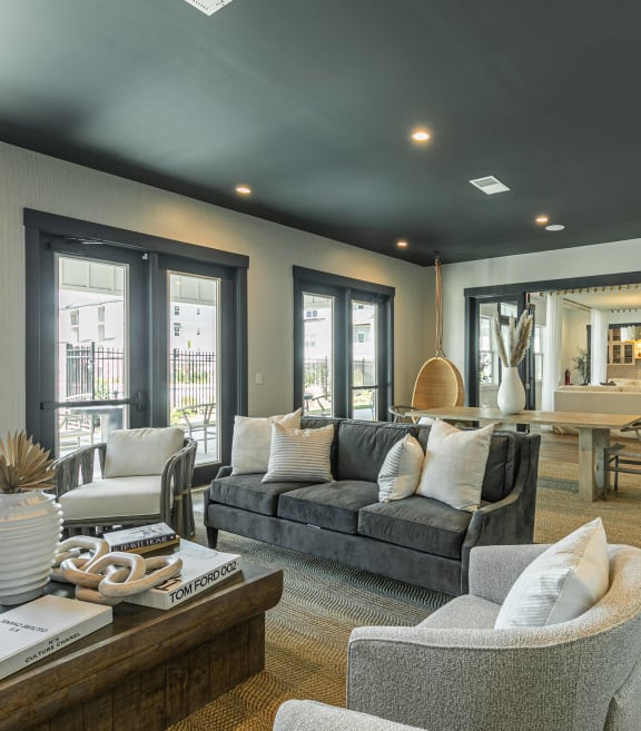 a living room with a couch and chairs and a table