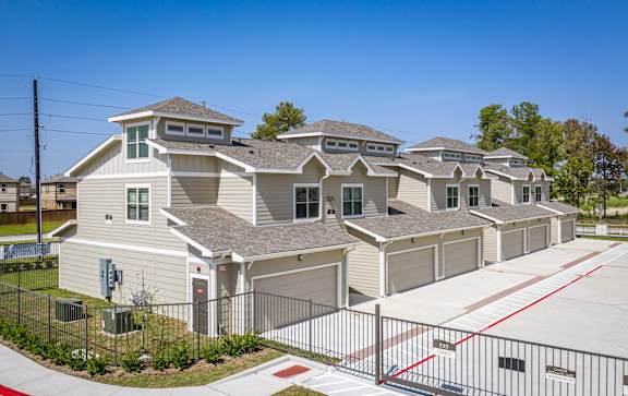 A row of houses with a red line painted on the driveway.