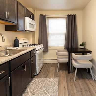 a kitchen and dining area with a table and chairs and a window