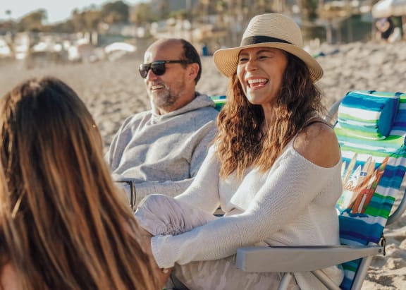 a group of people sitting in beach chairs on the beach