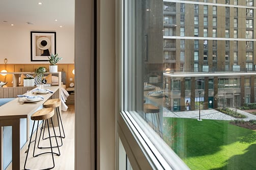 A modern kitchen with a dining table and chairs.