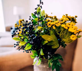A bouquet of flowers in a vase on a table.