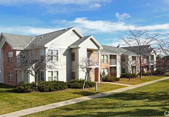a row of houses on the side of a sidewalk