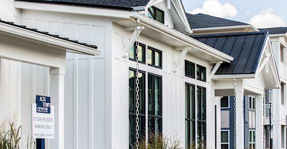 the exterior of a white home with black roof and windows