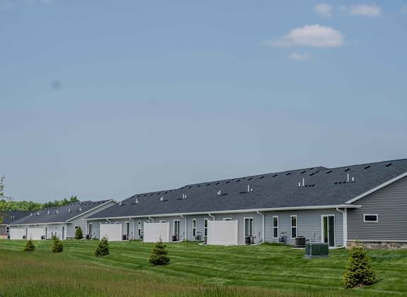 a row of houses with solar panels on the roof