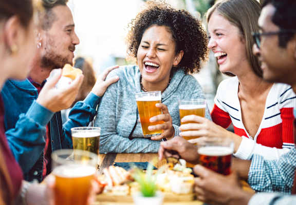 A group of people enjoying a meal and drinks together at Wheelhouse Lofts, Dayton, Ohio