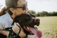 a woman and her dog in a field