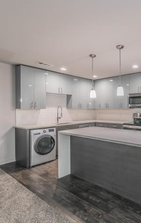 a modern kitchen with stainless steel appliances and a white counter top