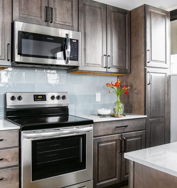a kitchen with stainless steel appliances and wooden cabinets
