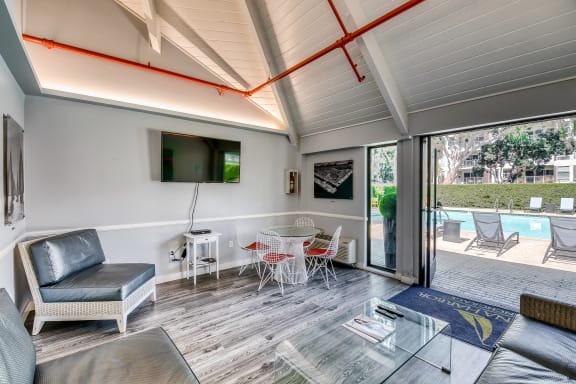 a living room with a couch and a table with chairs and a tv at Marina Harbor, Marina del Rey, California