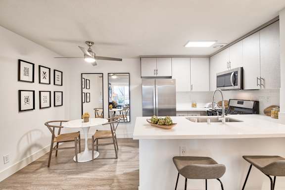 A modern kitchen with a dining table and chairs.