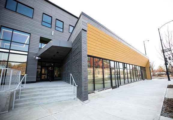A modern building with a combination of grey and yellow panels.