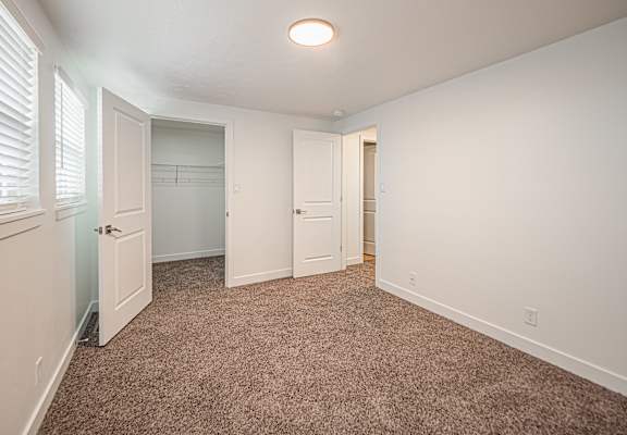 A room with carpeted floor and white walls.