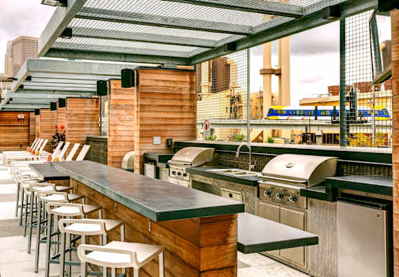 a bar with a row of stainless steel tables and chairs