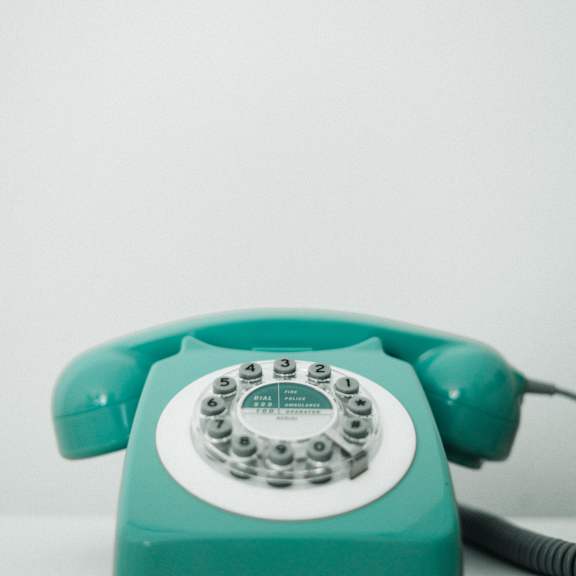 a turquoise telephone on a white table