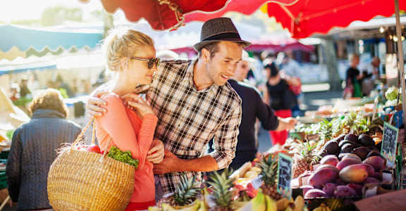 Man and a woman shopping at a fruit market