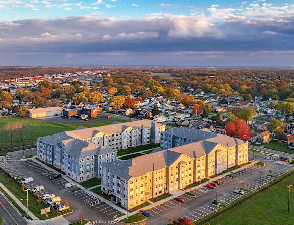 A large building with a parking lot in front of it.