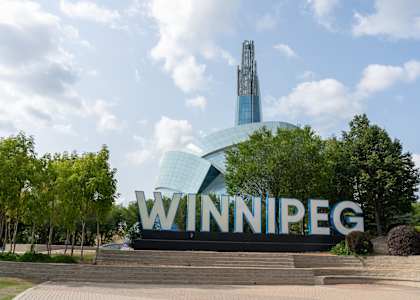 A large sign that says Winnipeg in front of a building.