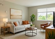 Thumbnail 6 of 8 - A living room with a grey couch, a coffee table, a lamp, a painting, a plant, and a window with blinds.