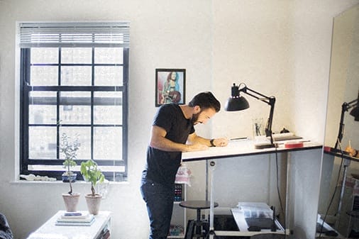 a man standing at a desk in a home office