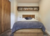 Thumbnail 1 of 8 - a bedroom with a bed in a room