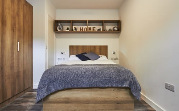 a bedroom with a bed in a room