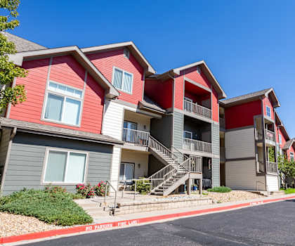 a row of houses with red and gray roofs on a street at Stetson Meadows Apartments, Colorado Springs, CO, 80922