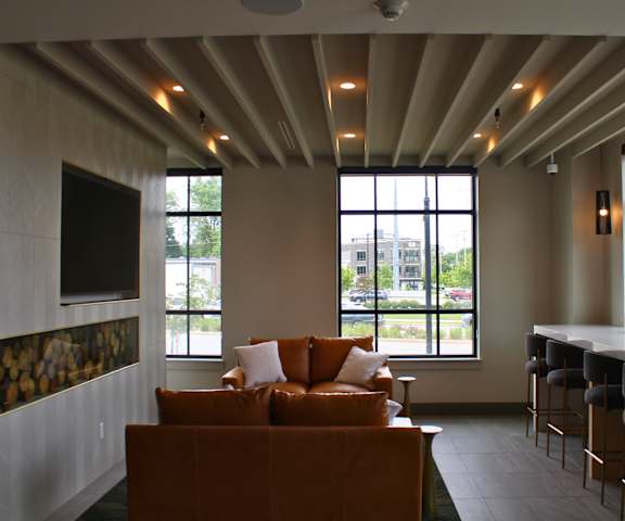A living room with a couch and a bar area.