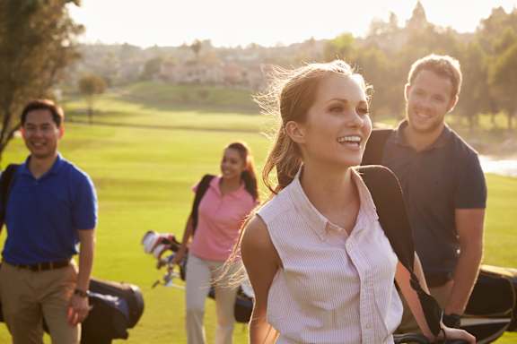 Group of people are walking on a golf course at The Bosk Apartment Homes, Woodbury, 55125