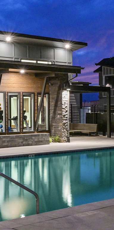 A modern house with a pool in the evening.